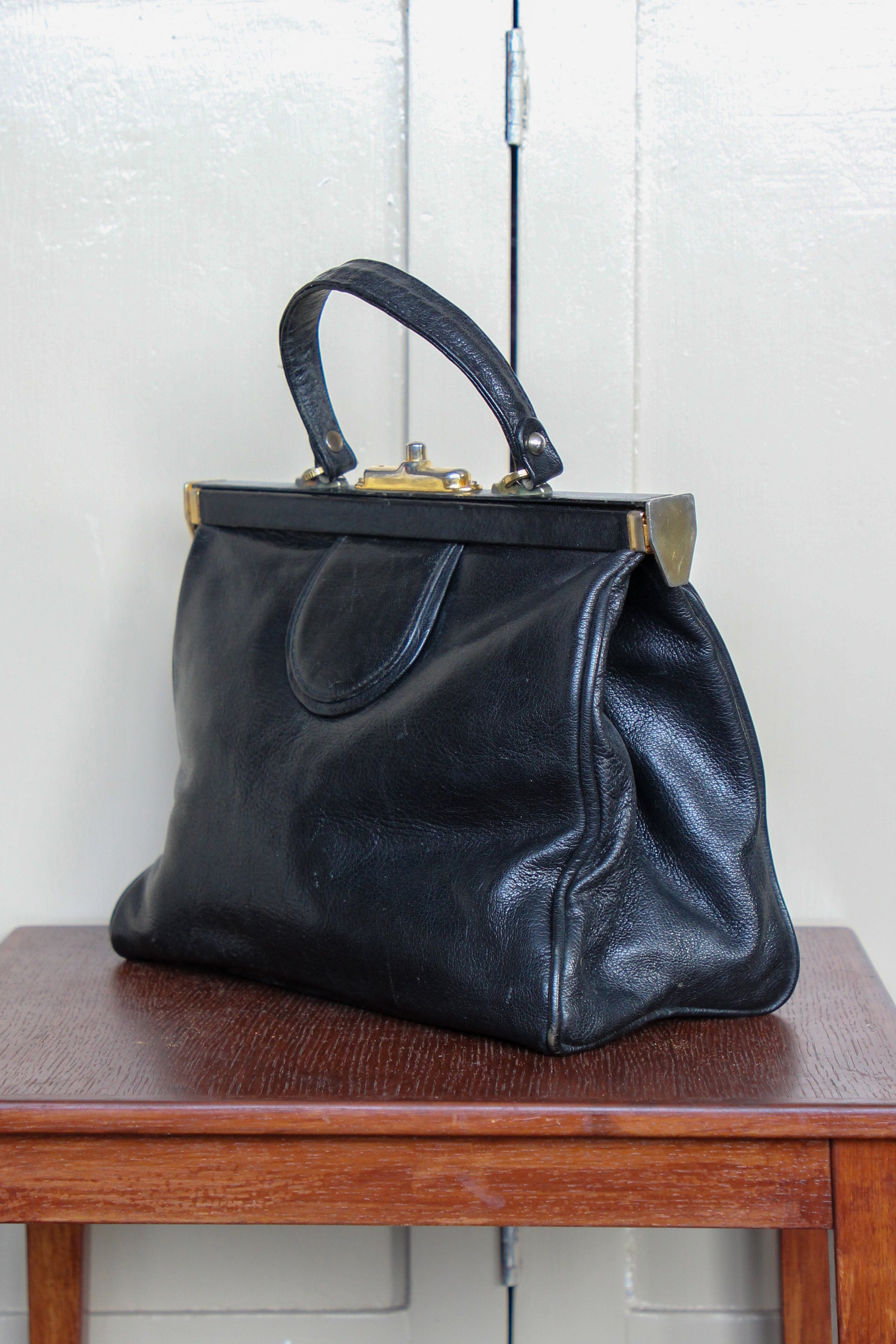 B141 1960s Vintage Black Leather Top Handle Bag with Red Linen