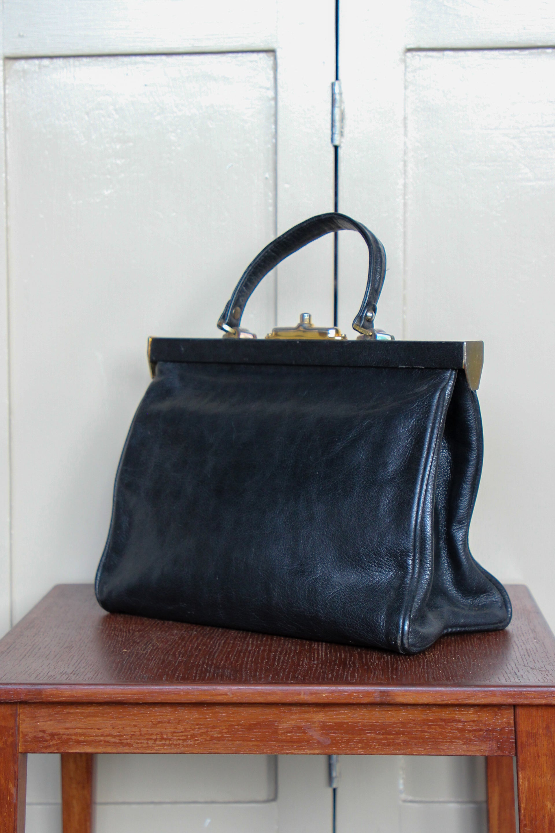 B141 1960s Vintage Black Leather Top Handle Bag with Red Linen